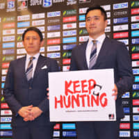 Sunwolves head coach Naoya Okubo (right) and CEO Yuji Watase pose for photos at a news conference in Tokyo on Tuesday. | KAZ NAGATSUKA