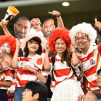 Japan supporters pose with masks of Brave Blossoms captain Michael Leitch at City of Toyota Stadium on Oct. 5. | DAN ORLOWITZ