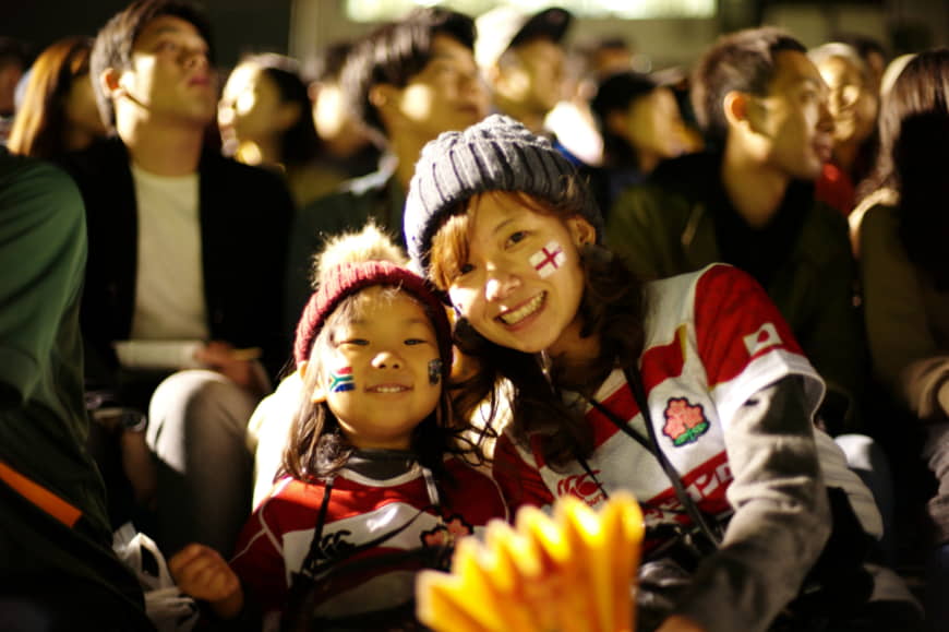 Ryoko Tokuda, 34, and her 5-year-old daughter Rinako attend a public viewing of the Rugby World Cup final match Saturday at Prince Chichibu Memorial Stadium. | RYUSEI TAKAHASHI