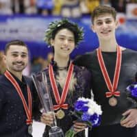 Men\'s champion Yuzuru Hanyu (center), runner-up Kevin Aymoz of France (left) and third-place finisher Roman Sadovsky of Canada are seen during the NHK Trophy awards ceremony on Saturday. | KYODO
