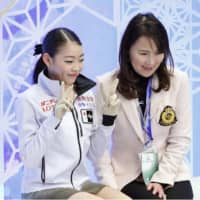 Rika Kihira (left) smiles with her coach Mie Hamada after performing in the women\'s free skate on Saturday. | KYODO