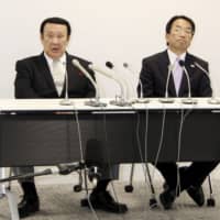 All Japan Taekwondo Association President Noboru Kanehara (left) speaks at a news conference on Wednesday. An outside panel chose not to reappoint Kanehara to the position after athletes protested in a call for reforms. | KYODO