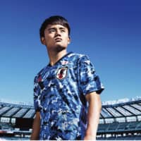 Takefusa Kubo models the new Japan national team uniform for Adidas. | KYODO