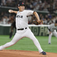 Giants pitcher Shun Yamaguchi, seen in action for Samurai Japan during the Premier12 final on Sunday at Tokyo Dome, will attempt to move to MLB via the posting system this offseason. | AP