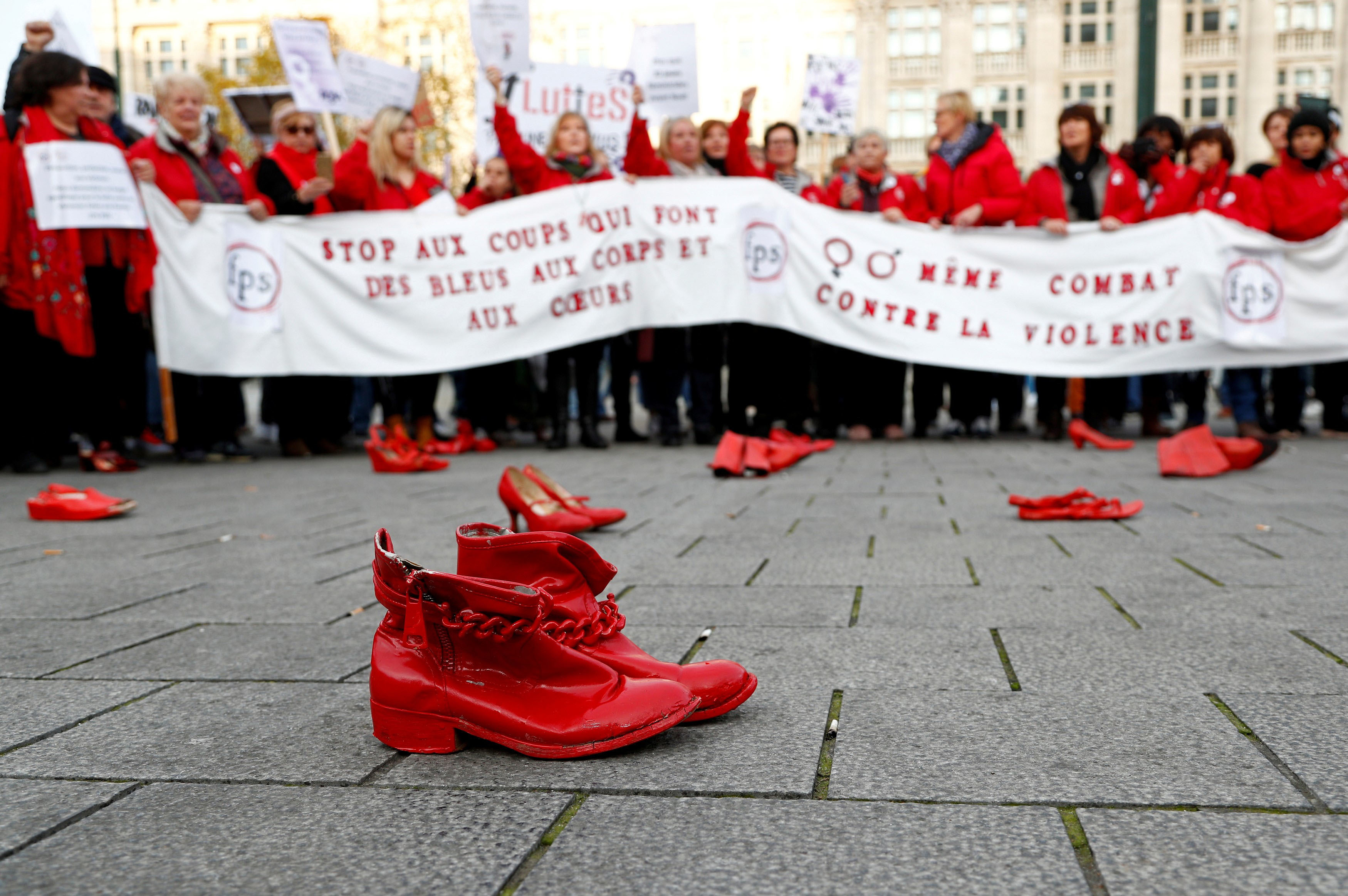 Red shoes are placed on the ground in central Brussels on Sunday during a demonstration against violence toward women. Police said about 10,000 people attended the protest, which took place on the eve of the International Day for the Elimination of Violence Against Women. | REUTERS