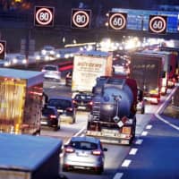 Trucks line up on a highway in Frankfurt, Germany, last year. Germany\'s parliament is poised to more than double the starting price for carbon dioxide emissions from the transport and heating industries when the charge is introduced in 2021. | AP