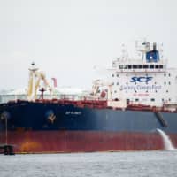 A crude oil tanker is moored in the Keihin industrial area of Yokohama in September. | BLOOMBERG