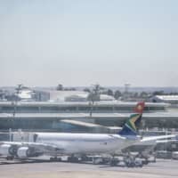 A South African Airways jetliiner is seen at the O.R. Tambo International Airport in Johannesburg Nov. 15. SAA was placed under a state-approved rescue plan Thursday as part of a restructuring process after a week-long strike was held last month. | AFP-JIJI