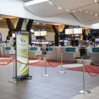 Empty SAA check-in counters are seen at the O.R. Tambo International Airport in Johannesburg last month. | AFP-JIJI