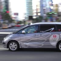 An autonomous taxi travels through Tokyo\'s Roppongi district last year. | ZMP INC. / HINOMARU KOTSU