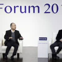 Masayoshi Son, chairman and chief executive officer of SoftBank Group Corp., speaks while Jack Ma, former chairman of Alibaba Group Holding Ltd., listens at Tokyo Forum 2019 in Tokyo on Friday. | BLOOMBERG