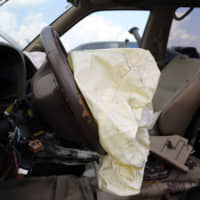 A deployed airbag is seen in a Nissan vehicle in May 2015 in Medley, Florida. | GETTY IMAGES / VIA KYODO
