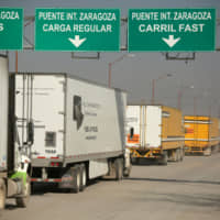 Trucks wait in a queue at border customs control to cross into the U.S. at the Zaragoza-Ysleta border crossing bridge in Ciudad Juarez, Mexico, last week. The U.S. House of Representatives passed legislation to implement the U.S.-Mexico-Canada Agreement by 385 votes to 41. | REUTERS