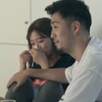 Can\'t touch this: While comforting Emika (left), Ryo\'s arm lingers on her knee &#8212; causing the panelists to speculate on their relationship on \"Terrace House Tokyo 2019-2020.\" | © FUJI TELEVISION / EAST ENTERTAINMENT