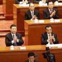 Chinese President Xi Jinping applauds during the closing of the Second Session of the 13th National People\'s Congress at the Great Hall of the People in Beijing on March 15. Xi has repeatedly called for training more capable cadres, and the Communist Party\'s Central Committee vowed in March to accelerate that by promoting the exchange of officials across local areas, departments and state-owned enterprises. | BLOOMBERG