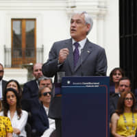 Chilean President Sebastian Pinera speaks at La Moneda presidential palace in Santiago on Monday during a ceremony to enact a law that enables a constitucional plebiscite. | RAMON MONROY / ATON CHILE / VIA AFP-JIJI