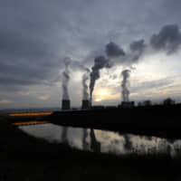 Smoke rises from chimneys of the Turow power plant located close to the Turow lignite coal mine near the town of Bogatynia, Poland, in November. | AP