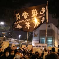 Hong Kongers gather outside a detention center in Lai Chi Kok to demand the release of protesters on Friday. | REUTERS