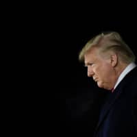 U.S. President Donald Trump arrives at W. K. Kellogg Airport as the House of Representatives debates his impeachment on Wednesday. | AFP-JIJI