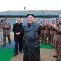 North Korean leader Kim Jong Un inspects the test-firing of a \"super-large multiple launch rocket system\" in this undated photo released Friday. | AFP-JIJI