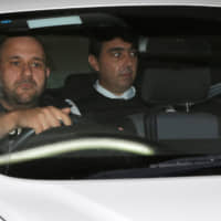 Melvin Theuma, who allegedly acted as a middle man in a plot to murder of journalist Daphne Caruana Galizia, is seen in a police car as he leaves the Courts of Justice in Valletta Wednesday. | REUTERS
