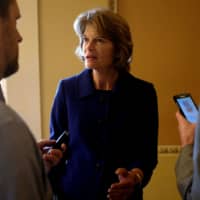 U.S. Sen. Lisa Murkowski speaks with reporters off the Senate floor in Washington in May. | REUTERS