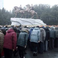 North Koreans bows in front of the bronze statues of their late leaders Kim Il Sung (left) and Kim Jong Il at the Mansudae Art Studio in Pyongyang Tuesday. | AP
