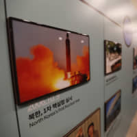 A photo showing a North Korean missile launch is displayed at the Unification Observation Post in Paju, South Korea, near the border with the North, on Friday. | AP