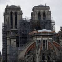 Work continues at the Notre Dame Cathedral in Paris Monday to stabilize the structure nine months after a fire caused significant damage. | REUTERS