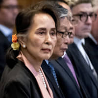 Myanmar\'s State Counsellor Aung San Suu Kyi stands before the U.N.\'s International Court of Justice on Tuesday in in the Peace Palace of The Hague at the start of a three-day hearing. | AFP-JIJI