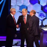 British Prime Minister Boris Johnson and Labour Party leader Jeremy Corbyn shake hands during a head-to-head debate on the BBC in London on Friday. | VIA REUTERS