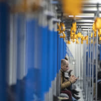 A man uses his smartphone in a subway train in Moscow Monday. Russia\'s Communications Ministry has scheduled an exercise for Monday that is intended to simulate what is being called the isolated operation of the internet. | AP
