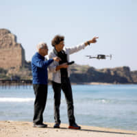 Israeli archaeologist Ehud Galili of the University of Haifa speaks to an Israeli photographer as they use a drone as part of their research work near Atlit, northern Israel, Wednesday. | REUTERS