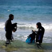 Israeli archaeologist Ehud Galili of the University of Haifa and his colleague prepare to dive in the Mediterranean Sea toward the area of Tel Hreiz where they believe an ancient seawall was erected, near Atlit, northern Israel, Wednesday. | REUTERS