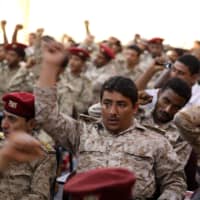 Army officers and soldiers who have defected from the ranks of Yemeni government forces shout Houthi slogans during a ceremony held by the Houthis in Sanaa Sunday. | REUTERS
