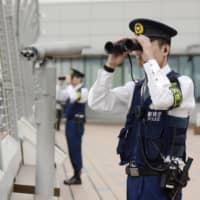 Police check for illegal drones at Tokyo\'s Haneda Airport on Oct. 17 ahead of the enthronement ceremony for Emperor Naruhito. | KYODO