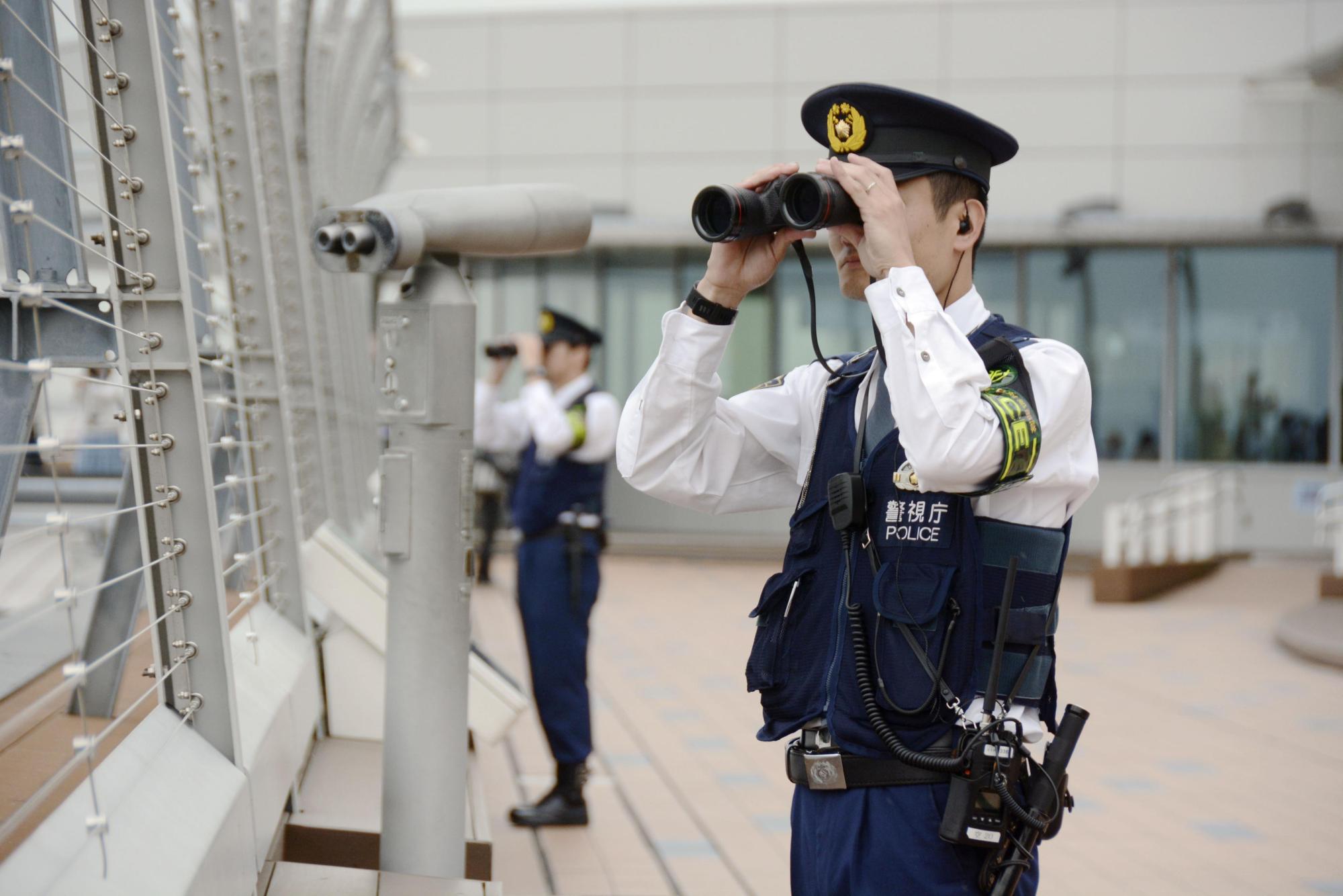 Police check for illegal drones at Tokyo's Haneda Airport on Oct. 17 ahead of the enthronement ceremony for Emperor Naruhito. | KYODO