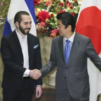 El Salvadoran President Nayib Bukele is greeted by Prime Minister Shinzo Abe in Tokyo on Nov. 29. | KYODO