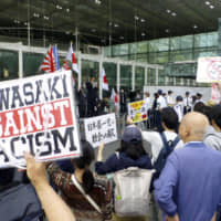 Counterprotesters denounce a rally by right-wing nationalists in Kawasaki in May. The city has passed an ordinance against hate speech that can lead to criminal penalties for violators. | KYODO