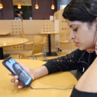 Sri Lankan national Dakshini Siriwardena, 21, talks on Skype with her younger sister, Pamalya, who left Japan after her father\'s business failure, on June 6. | CHISATO TANAKA