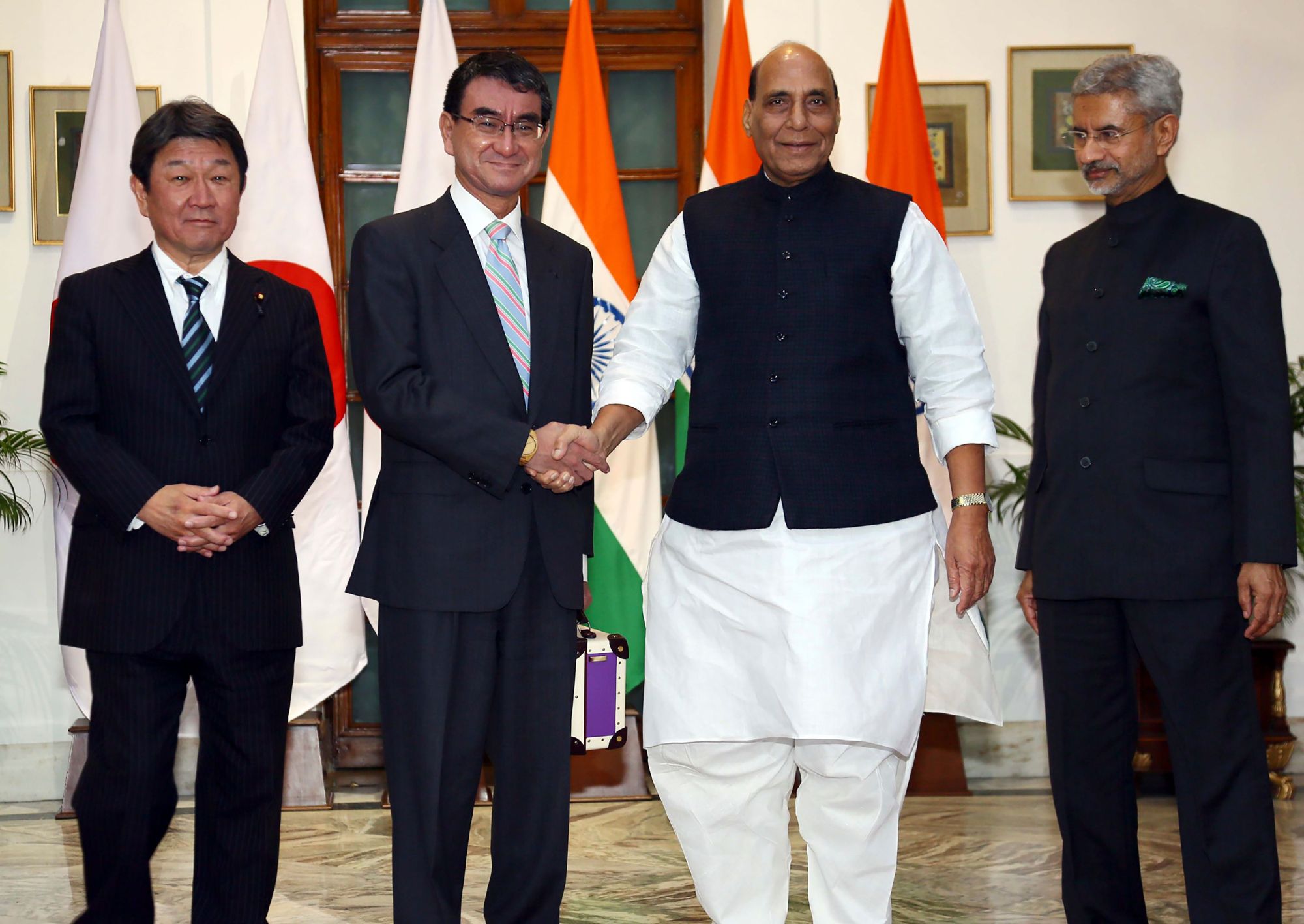 Defense Minister Taro Kono (second from left) greets his Indian counterpart Rajnath Singh as they pose with Foreign Minister Toshimitsu Motegi (left) and his Indian counterpart Subrahmanyam Jaishankar during their talks in New Delhi on Saturday. | AFP-JIJI
