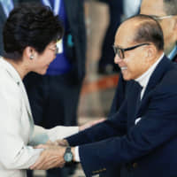 Tycoon Li Ka-shing shakes hands with Chief Executive Carrie Lam before voting during the election for Hong Kong\'s next chief executive in March 2017. | REUTERS