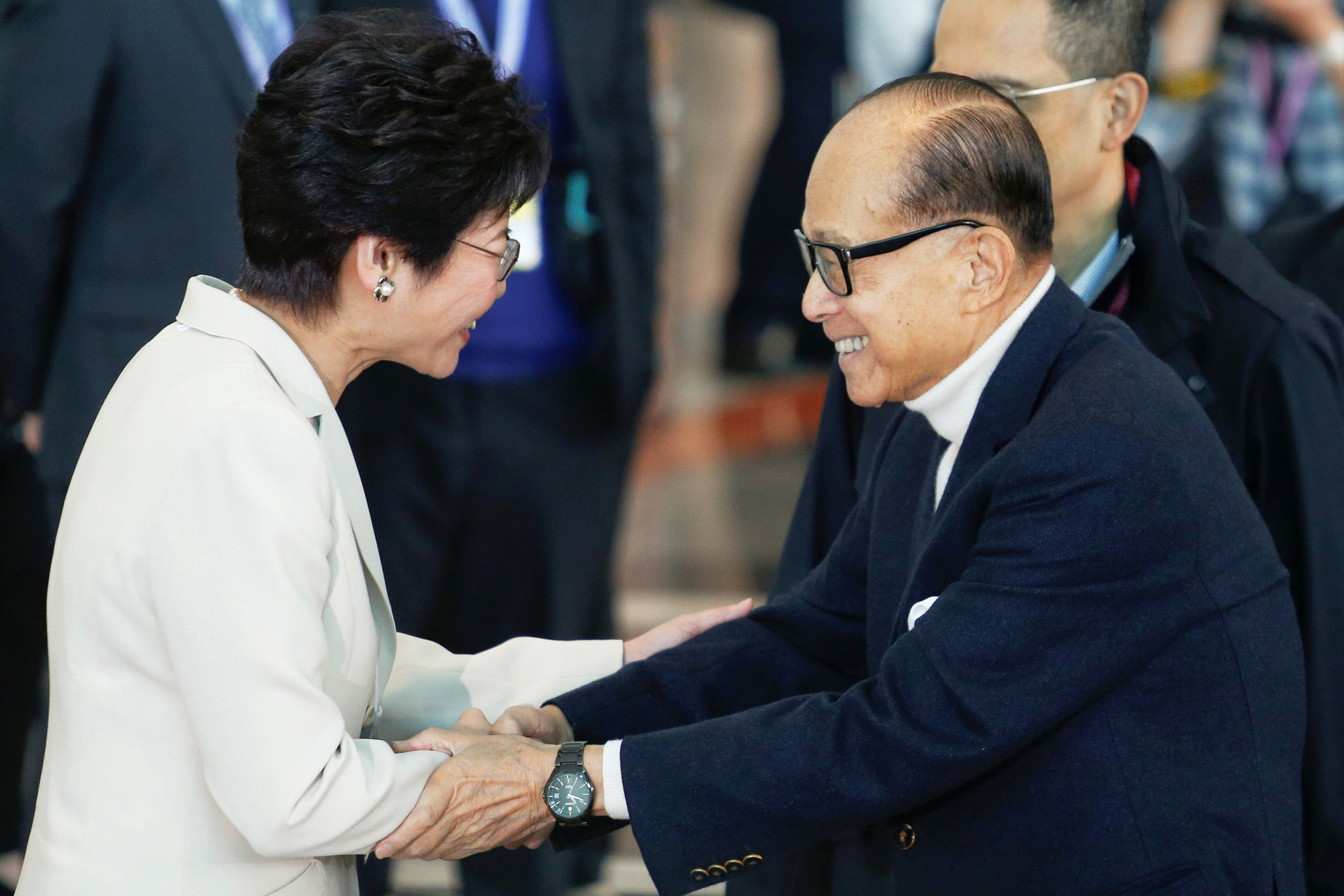 Tycoon Li Ka-shing shakes hands with Chief Executive Carrie Lam before voting during the election for Hong Kong's next chief executive in March 2017. | REUTERS