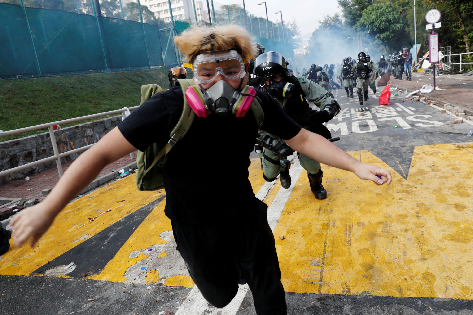 A protester from riot police at the Chinese University of Hong Kong on Nov. 12. | REUTERS