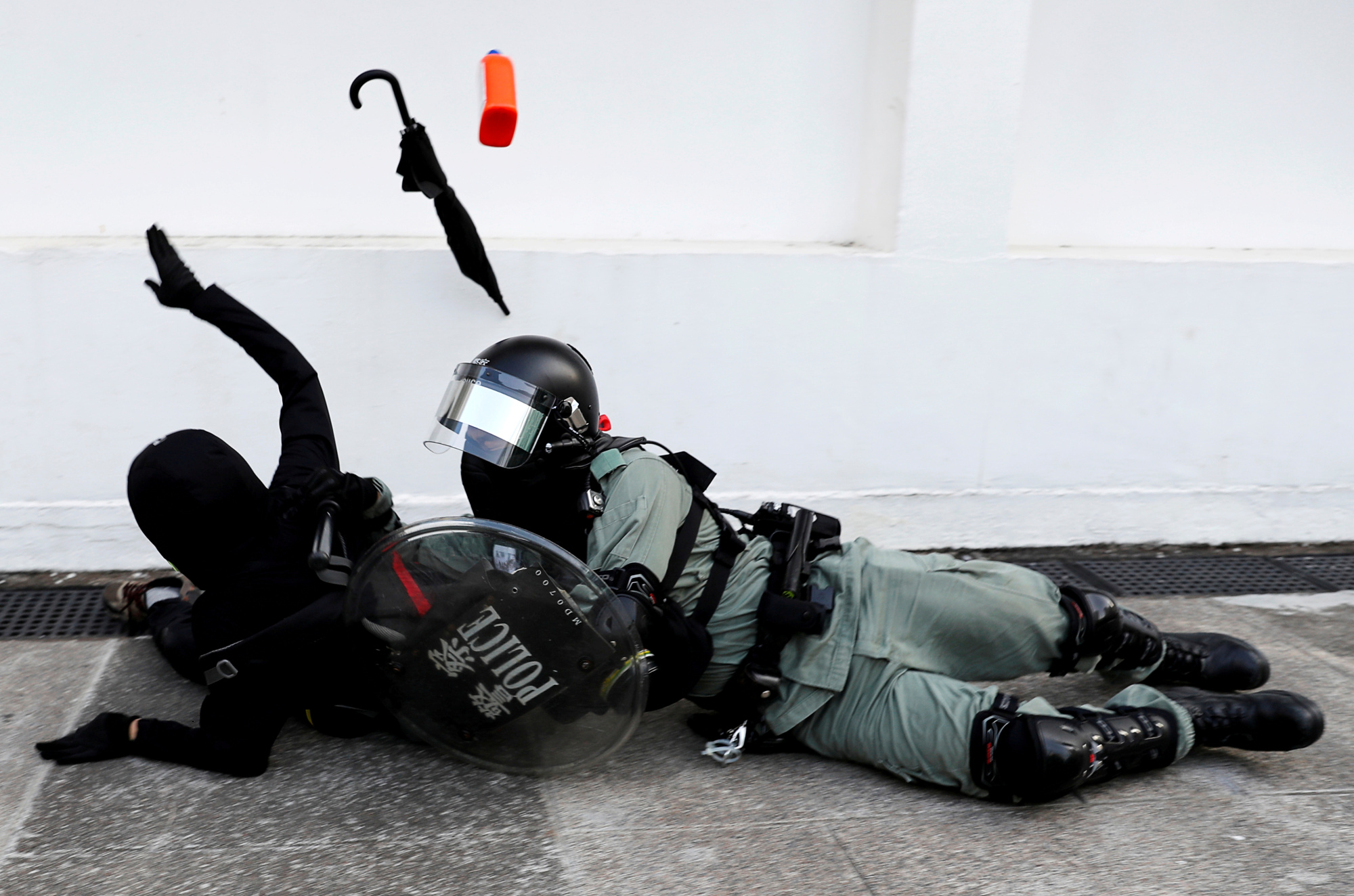 A riot police officer tries to subdue a protester during an anti-government demonstration in Hong Kong on Nov. 10. | REUTERS