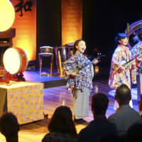Musicians play three-stringed instruments from Okinawa Prefecture known as sanshin during a Japanese traditional arts show at the Sydney Opera House on Monday. | KYODO