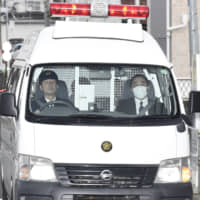 A police car carrying Satoshi Uematsu enters Tsukui Police Station in Kanagawa Prefecture in February 2017. | KYODO