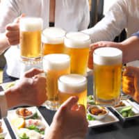 One last toast: Drinking is common at company end-of-year parties in Japan, but a recent survey suggests people are getting fed up with the events. | GETTY IMAGES
