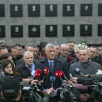 Kosovo President Hashim Thaci visits the Recak memorial on Dec. 10, where he called on Serbia to apologize for the genocide on his country as the first step toward a peaceful relationship. | AP