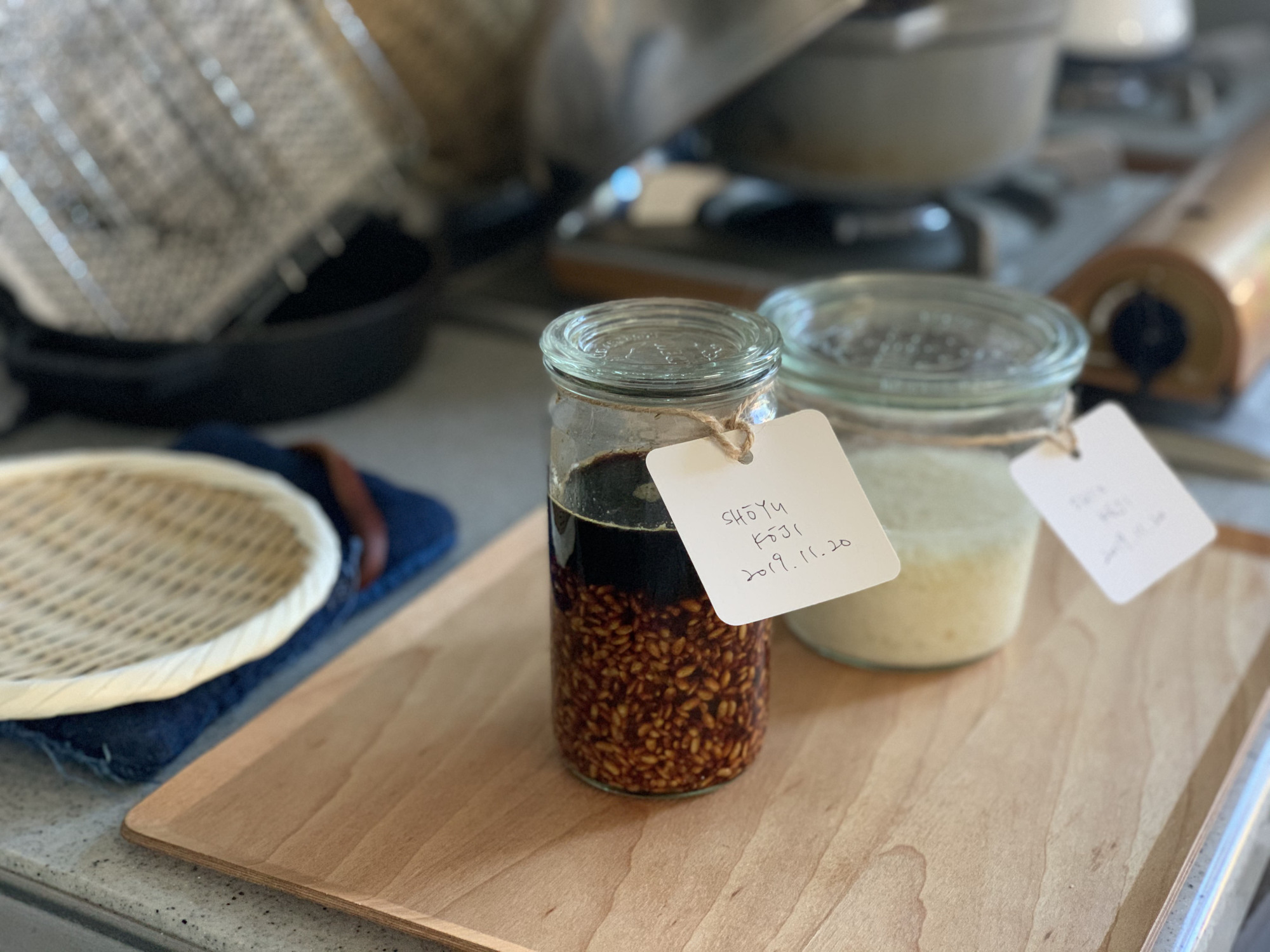 A very Japanese ingredient: A jar of neatly labeled shoyu kōji (a mixture of soy sauce and rice that has been inoculated with the mold Aspergillus oryzae) and shio kōji (salt kōji) ready for use in soups, marinades or dressings. | MOMOKO NAKAMURA